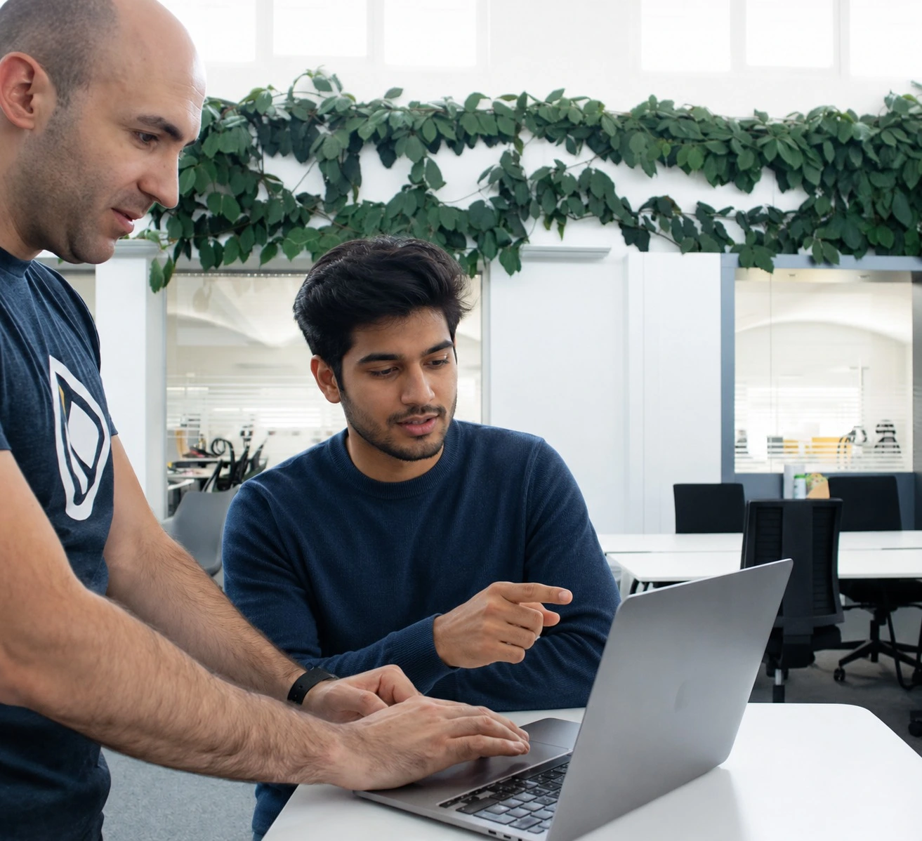 Two colleagues reviewing a campaign together on a laptop